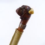 A Malacca walking cane with carved wood Bulldog's head handle, with sprung mouth and ivory ears,
