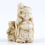 A Japanese Meiji period ivory carving of a Hotei and 2 boys, signed, height 4cm