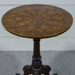 A 19th century circular walnut parquetry-topped table on carved base, 23" across