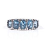 A 9ct white gold graduated 5-stone blue topaz half-hoop ring, setting height 7mm, size N, 2.4g