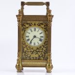 An ornate French brass-cased carriage clock with fretwork decoration, 8-day movement, case height