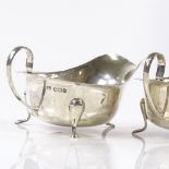 A pair of silver gravy boats, with scalloped rims, by Viners Ltd, hallmarks Sheffield 1933, length