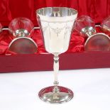 A cased set of 6 silver goblets, with engraved Adams style decoration, by Charles S Green & Co