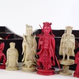 A large collection of Chinese/Cantonese half-stained carved ivory chess pieces (approx 55)
