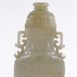 A large Chinese relief carved jade 2-handled vase and cover, on dark green jade pedestal, overall