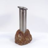A stainless steel cylinder vase in rough mineral stone base, height 21cm