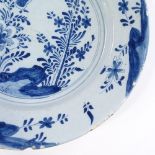 An 18th century blue and white Delft Pottery charger, with hand painted decoration, diameter 30cm