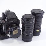 A Mamiya 645 1000s medium format film camera, with power winder grip and 5 lenses