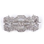 An Art Deco rose-cut diamond panel brooch, with unmarked white metal openwork geometric settings,