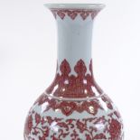 A Chinese white ground porcelain narrow-necked vase, with hand painted iron-red floral decoration,