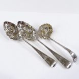 A pair of George III silver berry spoons, with bright-cut engraved decoration and relief embossed