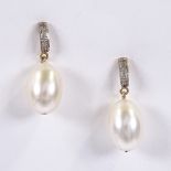 A pair of unmarked rose gold pearl and diamond drop earrings, with stud fittings, overall height