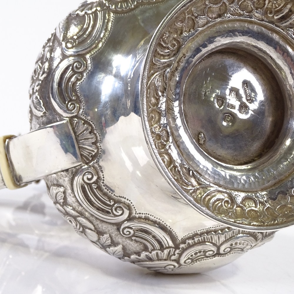 A George IV Irish silver coffee pot, with relief embossed floral and foliate decoration, with - Image 4 of 4