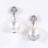 A pair of Baroque pearl and diamond drop earrings, with unmarked white metal stud fittings, each