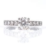 De Beers - a 1ct solitaire diamond ring with diamond set shoulders, approx 1ct total, total