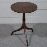 A 19th century circular mahogany tilt-top wine table on tripod base, 19.5" across