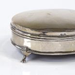 An Edwardian oval silver jewel box, with hinged lid and green felt interior, by Henry Emmanuel,