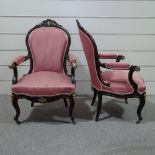 A pair of mahogany-framed fire side armchairs, carved show-wood surrounds, and ornate brass mounts