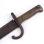 A 19th century French sword bayonet with brass handle, original metal scabbard, overall length 71cm
