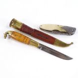 A traditional Finnish Puukko belt knife in leather scabbard, signed blade and brass horse design