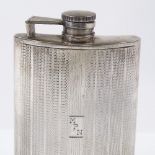 A sterling silver curved hip flask, with engine turned decoration, height 12.5cm, 5oz