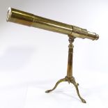 A brass table telescope on brass tripod stand