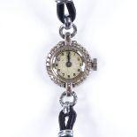 A lady's platinum cocktail wristwatch, with diamond set bezel and leather strap, case width 16mm,
