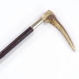 A hunting crop with leather thong and horn handle, by Swaine of London