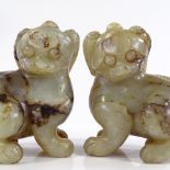 A pair of Chinese carved green stone/jade Dogs of Fo, height 14cm, length 13cm