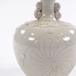 A Chinese white glaze porcelain vase, with relief embossed decoration, height 16cm