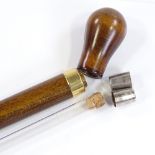 A stained wood spirit cane with screw-on handle and glass tube lining