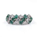 An 18ct white gold emerald and diamond cluster dress ring, total diamond content approx 0.9ct,
