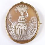 An oval relief carved cameo panel brooch, depicting lady with flowers, in gold frame, panel height