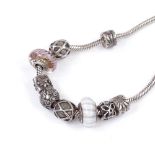 A sterling silver charm necklace with 9 Pandora silver charms, necklace length 43cm, 51.2g