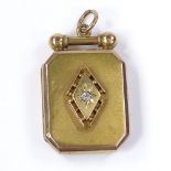 A 15ct gold diamond set panel photo locket, with central starburst decoration and textured back,