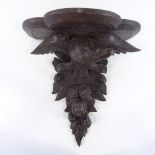 A Victorian carved oak wall bracket supported by an eagle, height 46cm, width 44cm