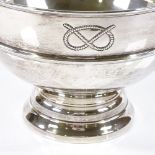 A large circular silver table centre fruit bowl, with relief embossed overhand knot motif, hallmarks