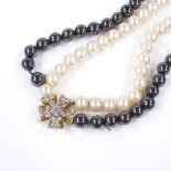 A 2-colour double strand pearl choker necklace, with unmarked gold diamond set spacer and silver-
