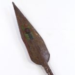 A Papua New Guinea Tribal carved and painted wood ceremonial spear paddle, length 1.3m