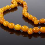 A string of polished butterscotch amber beads, bead length 14.6mm, 51g