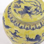 A Chinese yellow ground porcelain jar and cover, with blue painted dragon designs, 6 character mark,