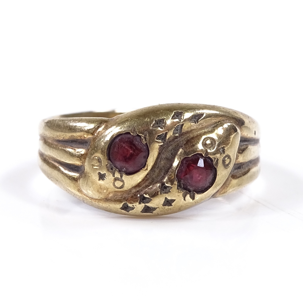 A 9ct gold garnet double snake head ring, setting height 9.7mm, size Q, 2.7g