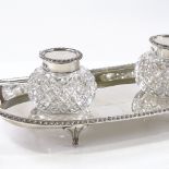 An Edwardian silver and cut-glass desk stand inkwell, with gadrooned rim, by James Deakin & Sons,