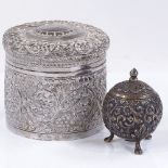 An Eastern circular silver box, with relief embossed grapevine decoration, height 8cm, together with