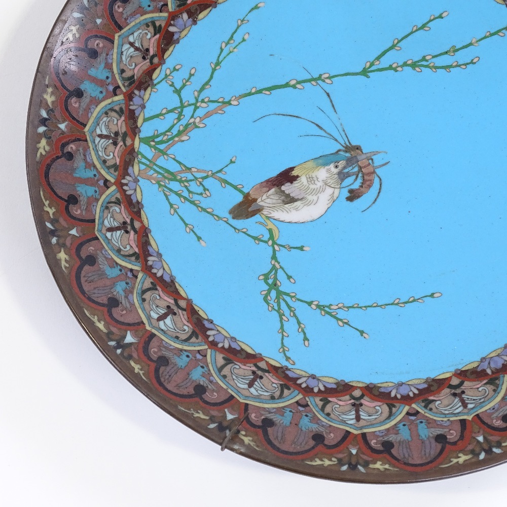 A pair of Japanese cloisonne enamel plates decorated with birds and their catch, diameter 30cm