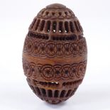 A carved and pierced coquilla nut box with screw-top, height 6.5cm