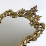 An ornate cast and pierced gilt-brass framed wall mirror, height 105cm (41")