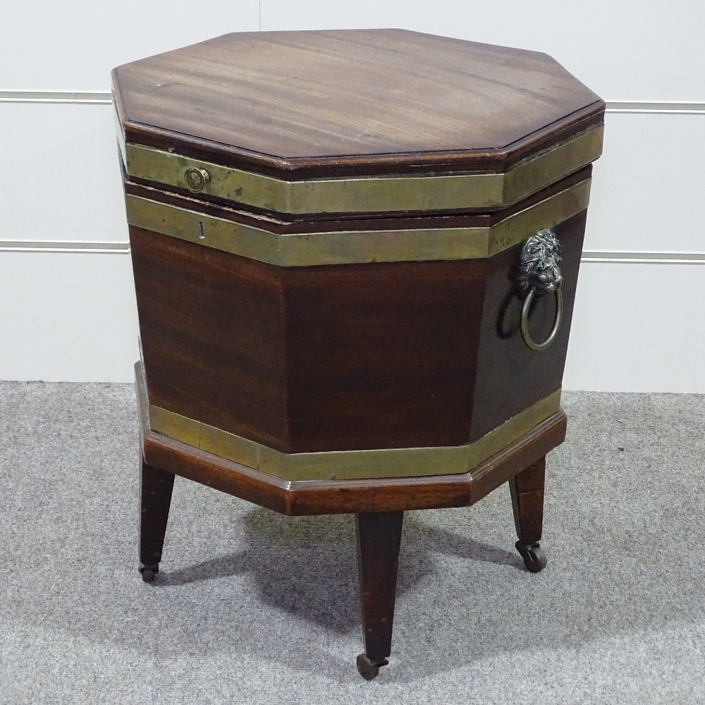 A George III brass-bound mahogany wine cooler of octagonal form, on tapered legs, with brass lion - Image 2 of 8