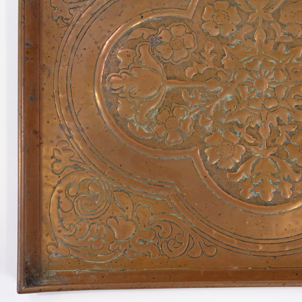 A Keswick School of Industrial Arts copper tray with relief embossed floral designs, 43cm x 36cm