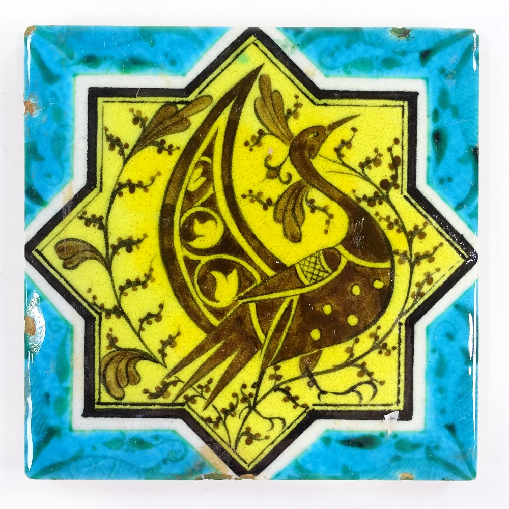 An Islamic turquoise/yellow glaze tile with peacock design, 19.5cm across